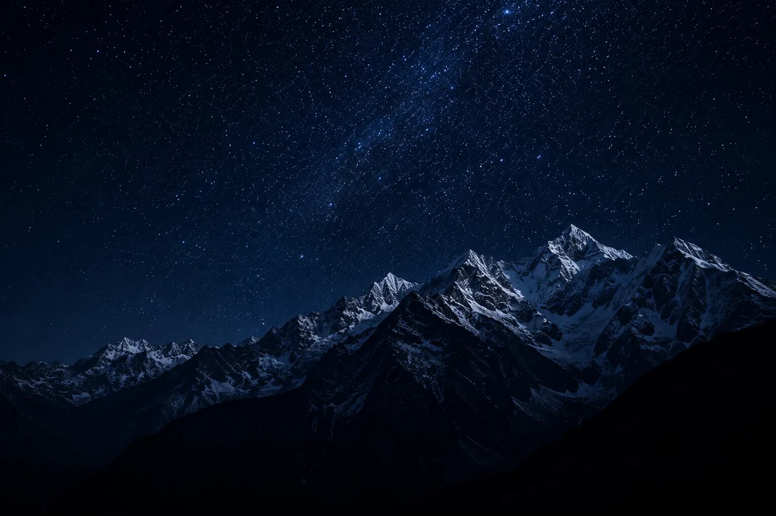 Himalayan peaks under a starlit night sky